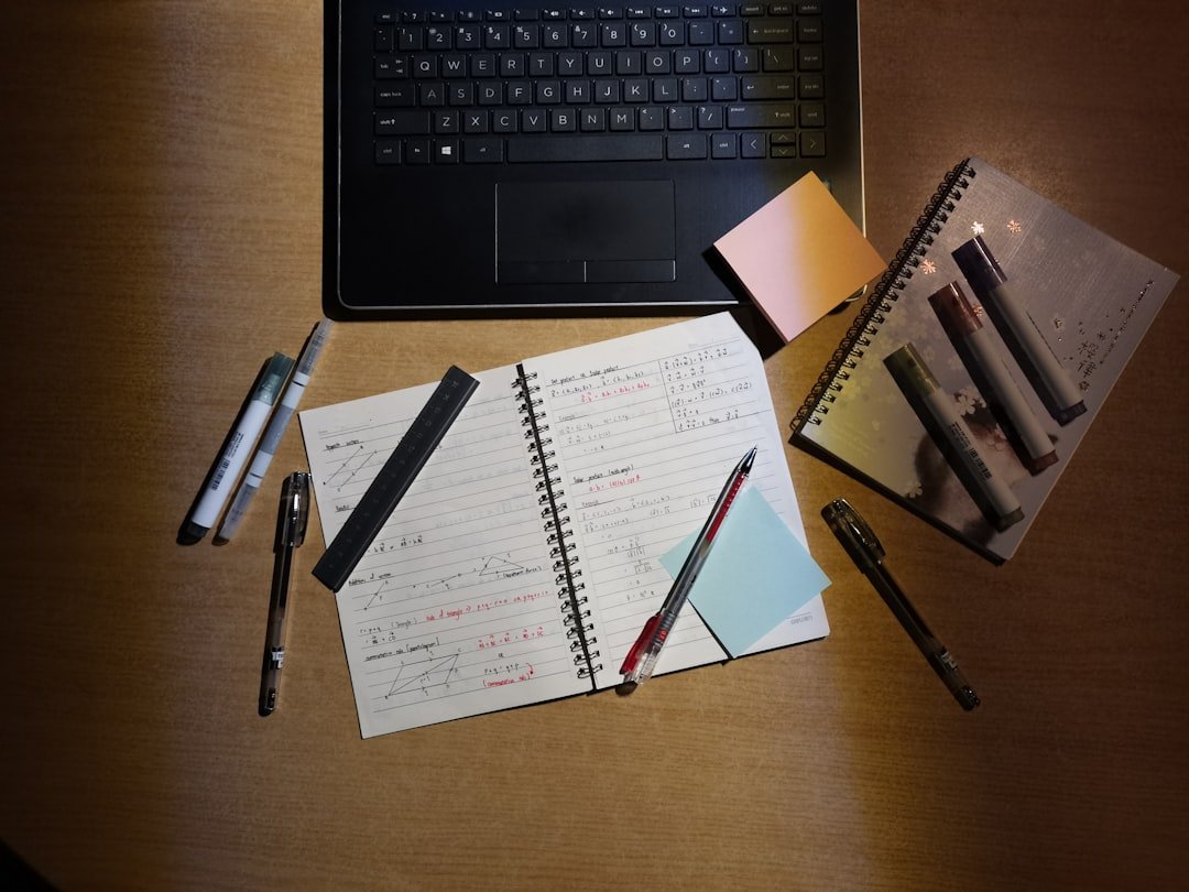 a laptop computer sitting on top of a wooden desk
